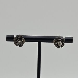 silver tone flower stud earrings with clear crystal center